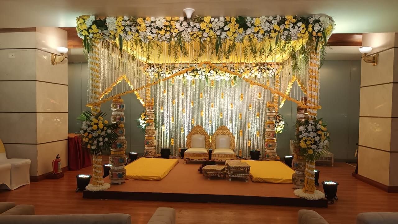 A beautifully decorated Haldi mandap adorned with vibrant flowers and twinkling lights at The Orchid Hotel Mumbai Vile Parle