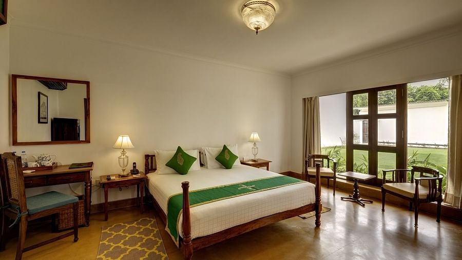 Residency Room at Saraca Hotel, Lucknow with a double bed and a chandelier