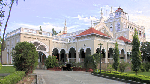 A palace with plants and pathway.