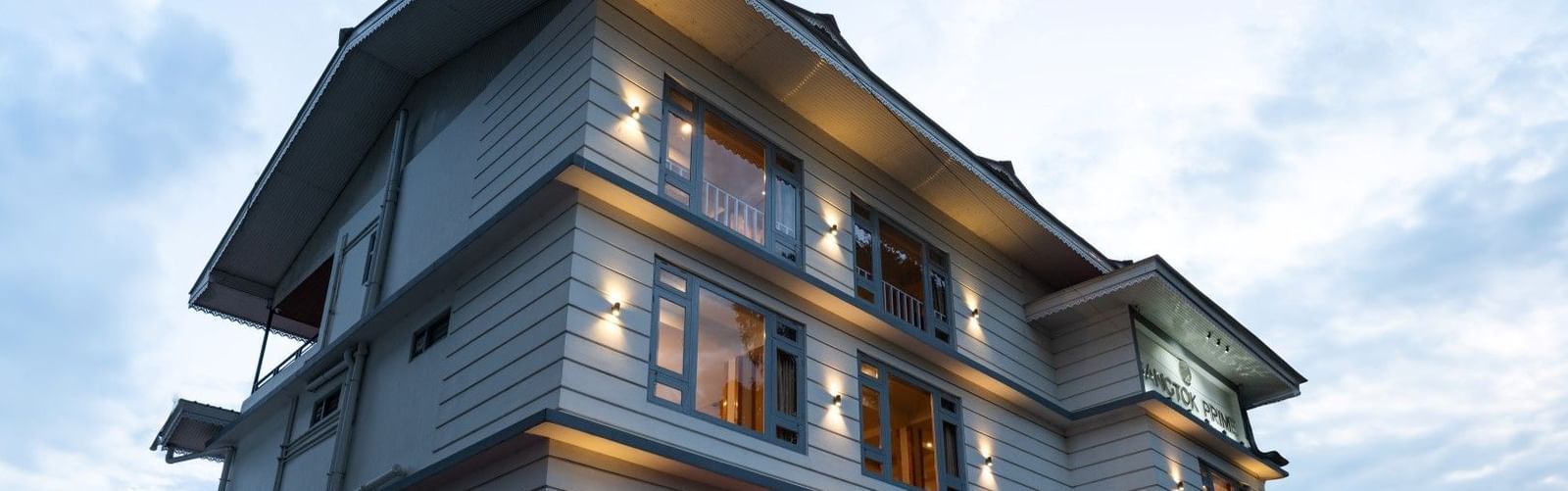 An image of a three storey building and there's also a sky in the background - Avianna Group of Hotels & Resorts