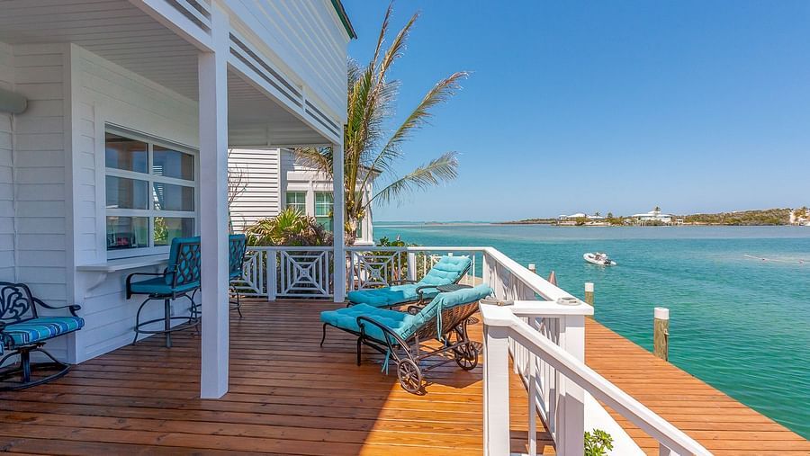 Covered porch with seating and views of calm turquoise waters | Abaco Inn
