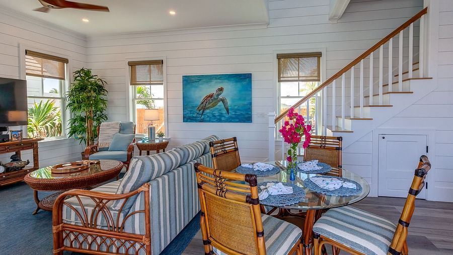 Open-plan living and dining area with wooden furniture and a staircase | Abaco Inn