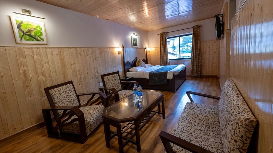 Side view of suite room with two chairs and a sofa at The Pavilion, Nainital