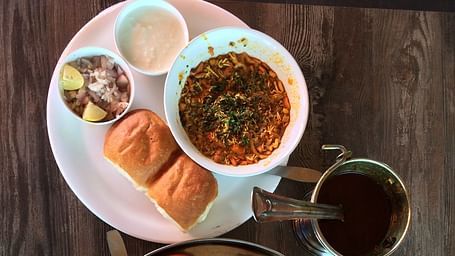Aerial view of Maharashtrian dishes kept on plates on top of a table.