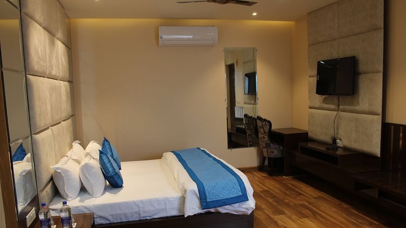 Mastiff Hotel in Dalhousie presents a side perspective of a room featuring a comfortable, luxurious bed - Mastiff Hotel, Dalhousie