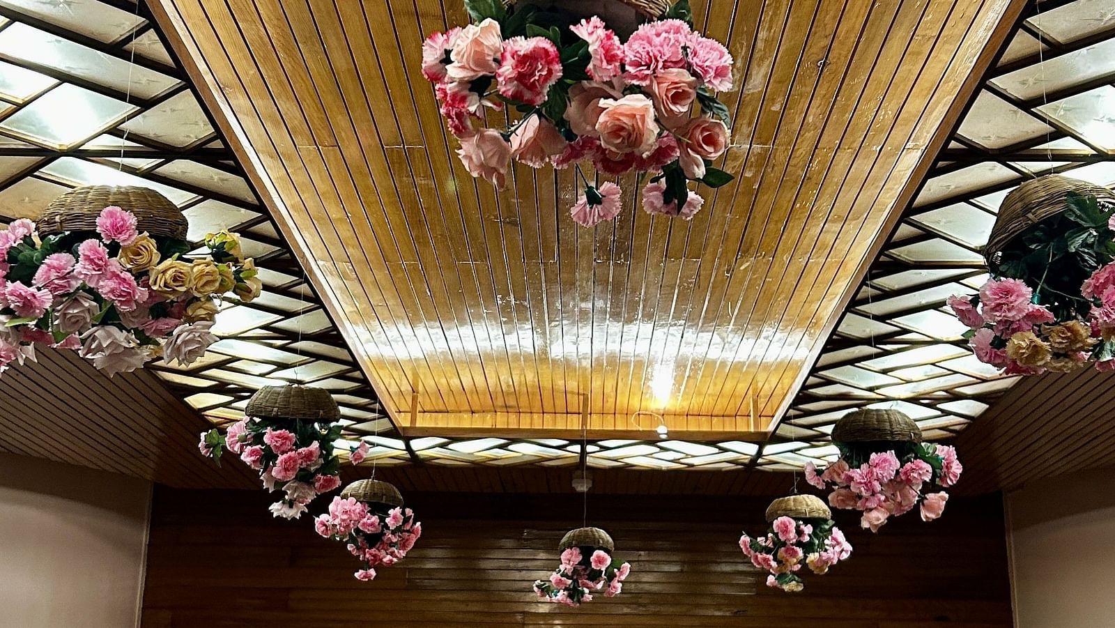 Indoor wedding setup at Cedar Inn, Darjeeling, featuring a decorated ceiling canopy and cosy seating area.