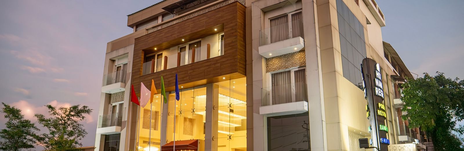 The exterior of Mansha Hotel Regency, a multi-storey building with a modern design, captured during early evening | Mansha Hotels