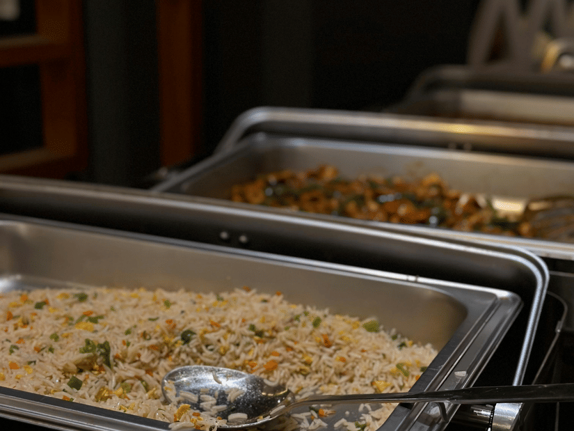 A standard buffet service featuring stainless steel chafing dishes lined up on a table. These dishes are commonly used in catering for events such as holiday parties, corporate luncheons, and restaurant brunches to keep food warm.