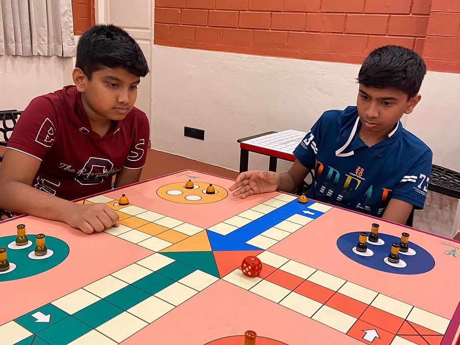 kids playing ludo inside the game room  - Ibex River Resort, Pollachi