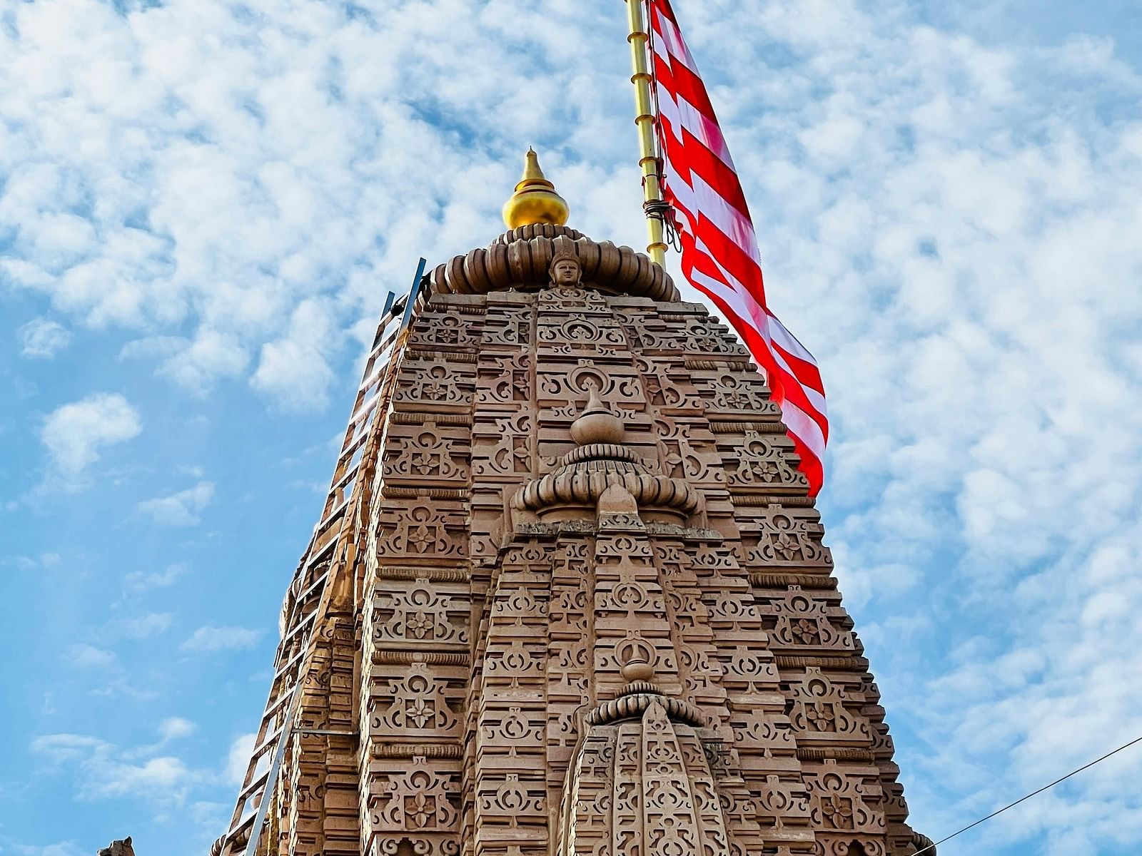 A close-up view of a temple top with a flag at the top