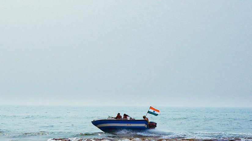 a speed boat cruising across a river in Konark