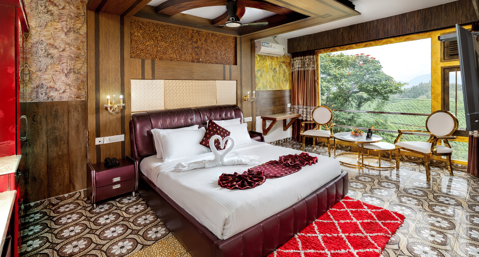 A sleeping area in the Double Bedroom Pool Villa at Parakkat Nature Hotel and Resorts, Munnar, featuring decorative wood ceiling work, a large bed, and expansive windows overlooking the landscape.