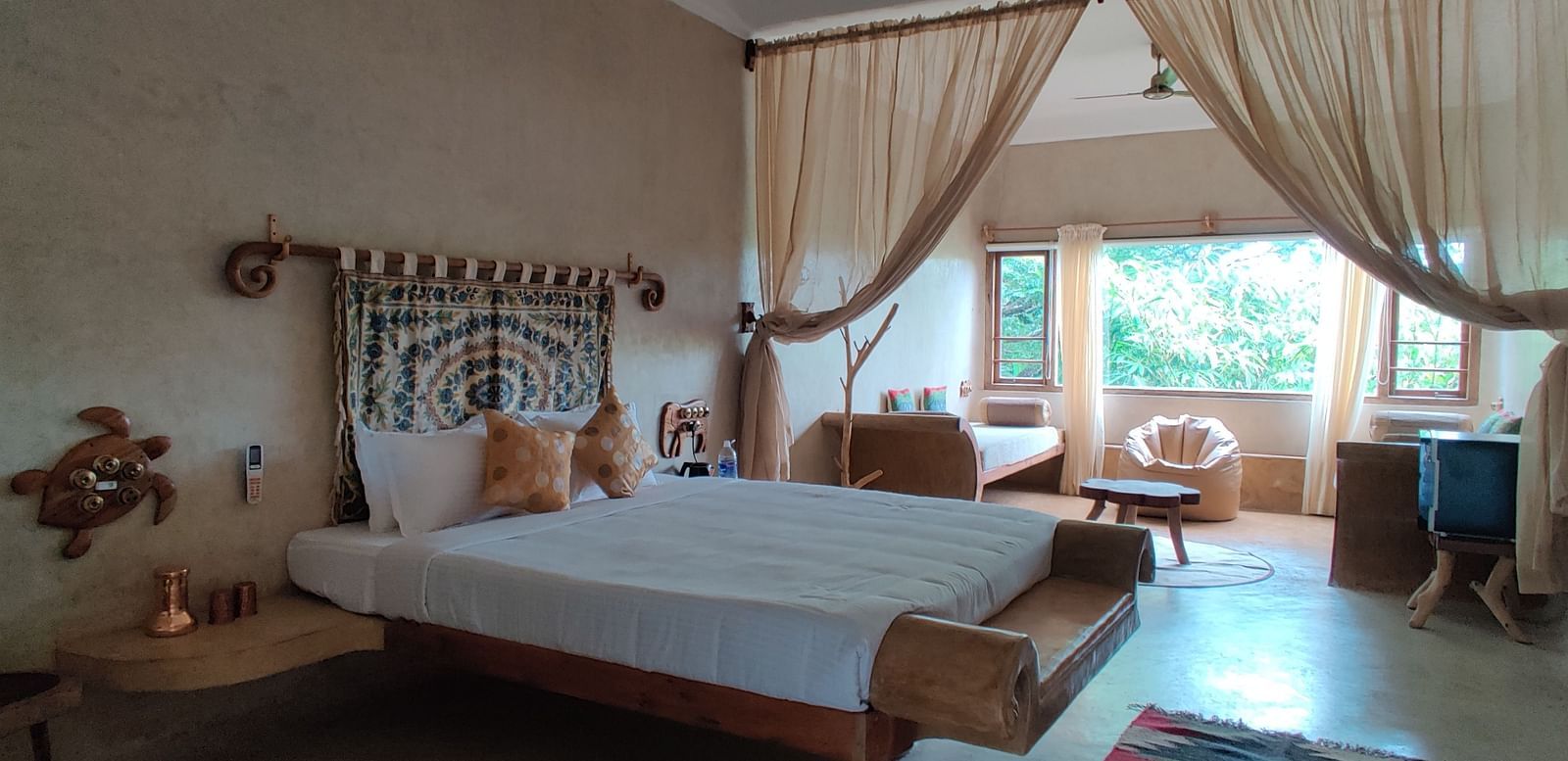 King-size bed and big windows that provide a glorious glimpse into the outside world.