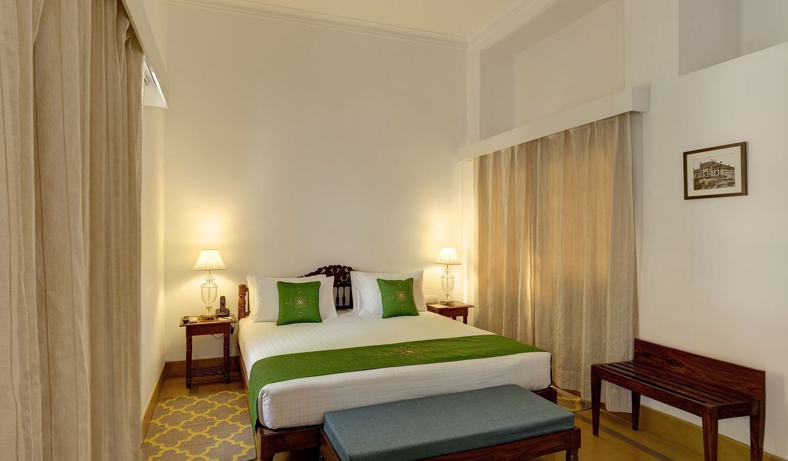 a room featuring a bed with a foot rest at Saraca Lucknow