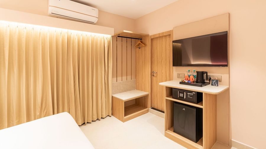  Kitchenette with a fridge and wardrobe in The Executive Rooms at Livancia The Sojourn, Bangalore.