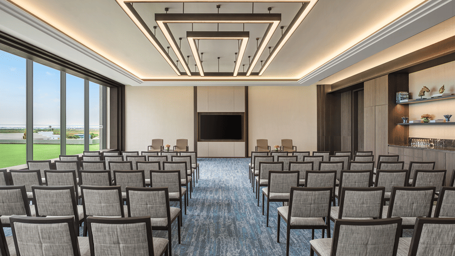 Council Room 3 set up in theatre style with rows of chairs and window view at The Residency Signature Madurai.