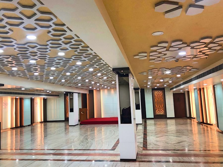 an empty Banquet Hall in Tirupati with many lights switched on - Raj Park Hotel, Tirupati