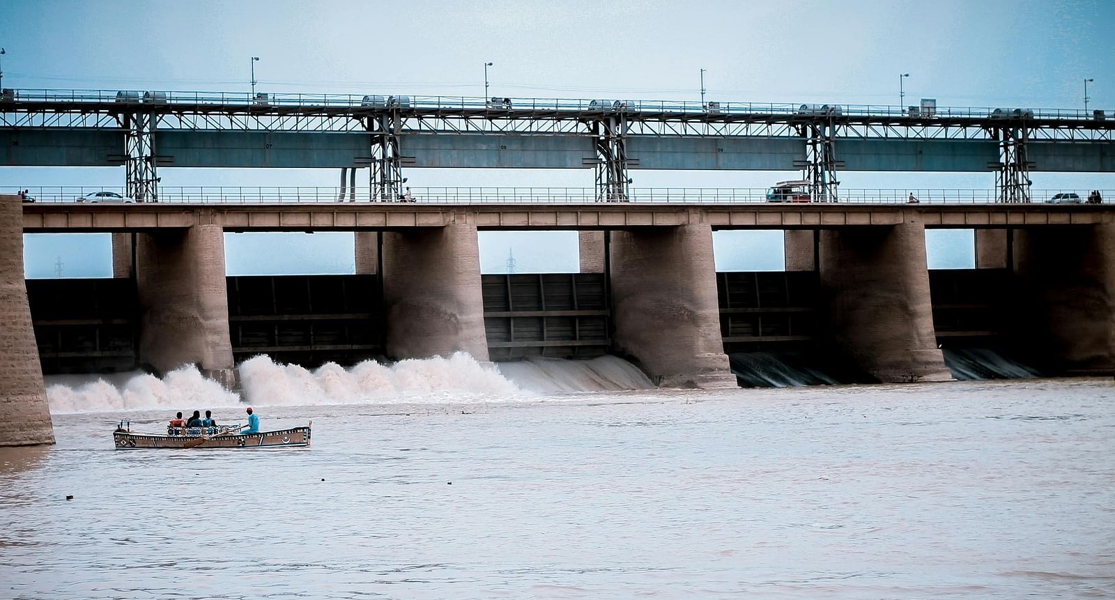 An image of a dam with a boat nearby in the waters
