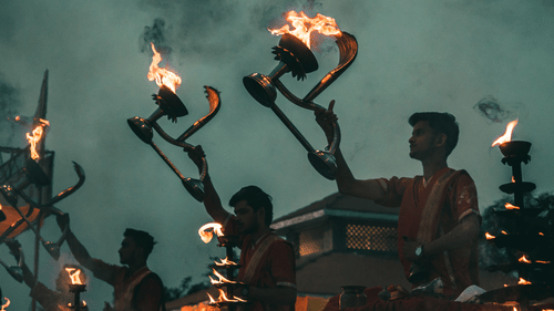 priests performing an aarti at a temple