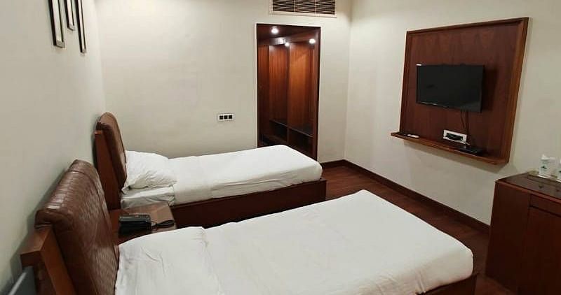 The Luxury Room from a higher angle featuring a wall mounted television in front of it - Hotel Gold, Panipat
