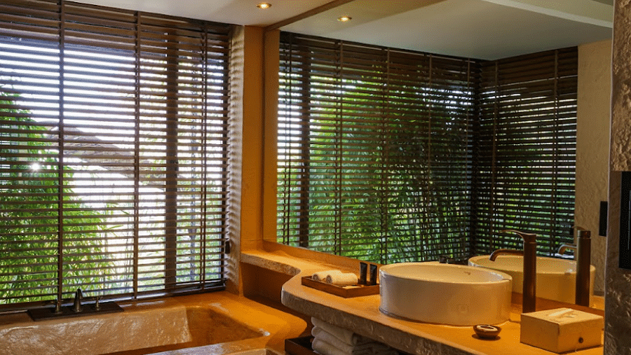 A large bathroom with huge mirror and window covered by blinds | Kavya Resort and Spa, Nagarkot