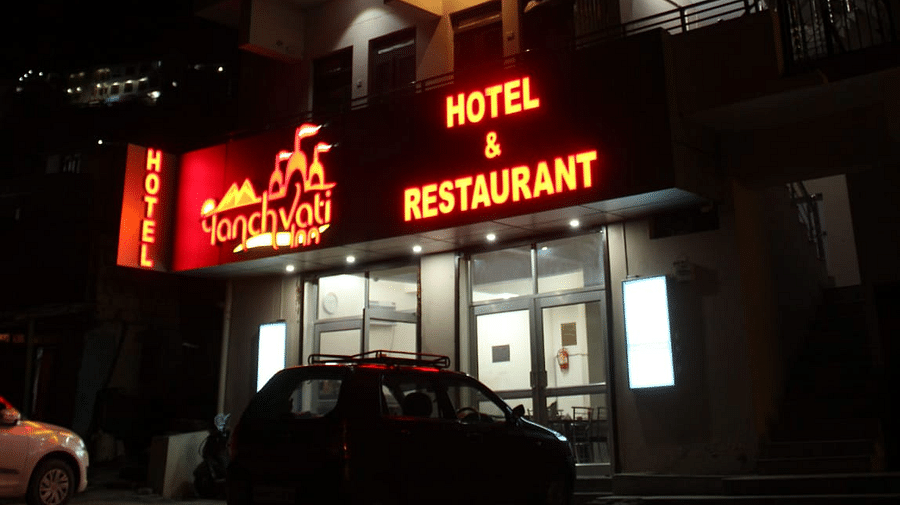Facade of Hotel Panchvati Inn with cars parked outside 2