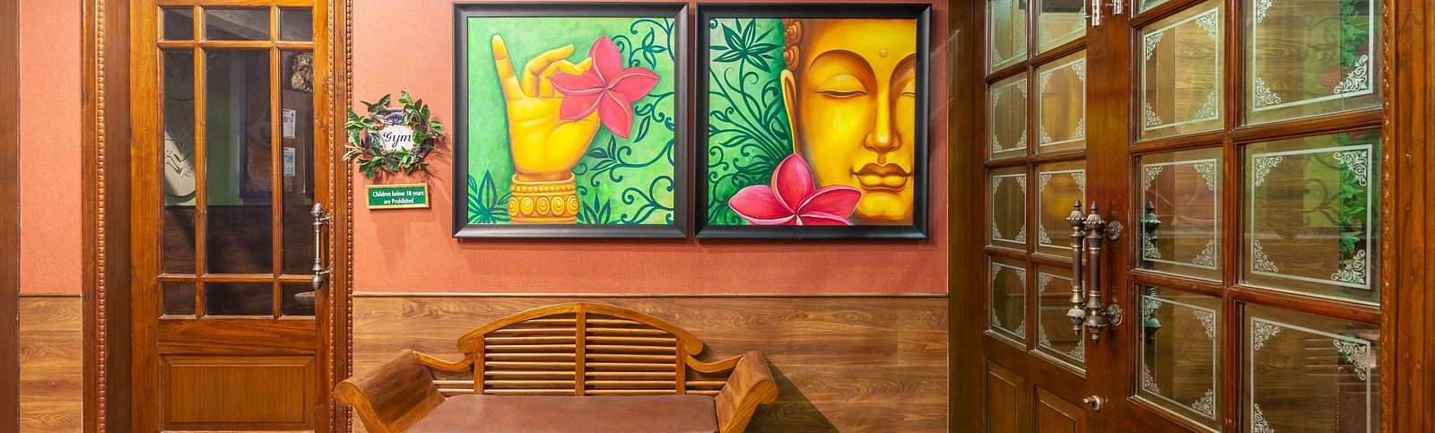 a wall filled with two paintings and a sofa in front of the wall - Mayfair Palm Beach Resort, Gopalpur-on-Sea