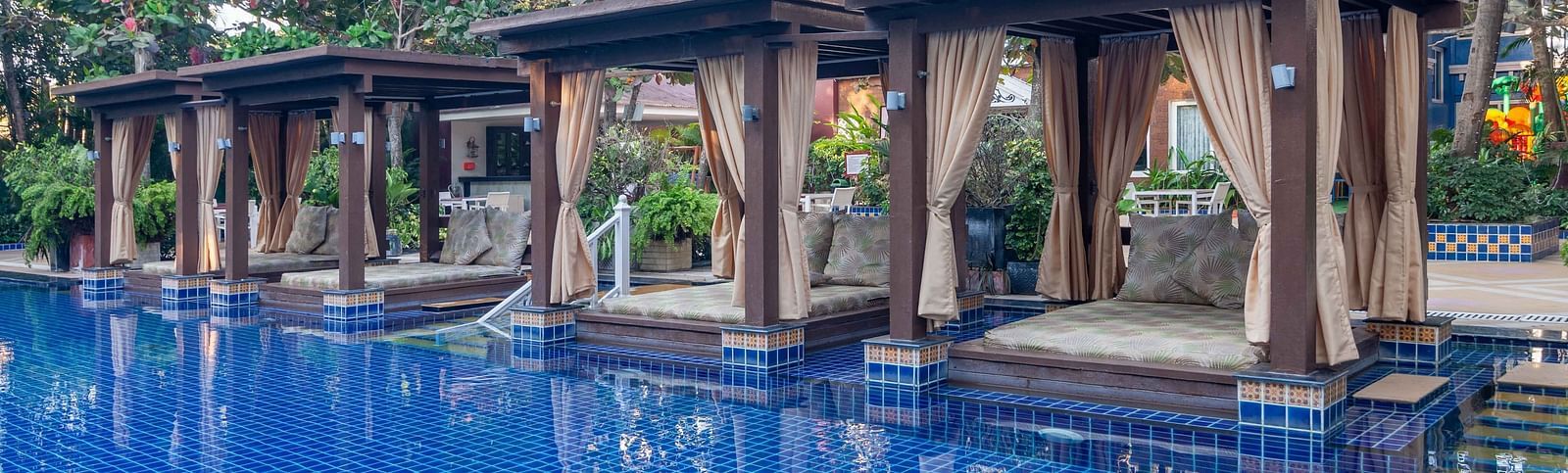 swimming pool along with poolside beds - Mayfair Palm Beach Resort, Gopalpur-on-Sea