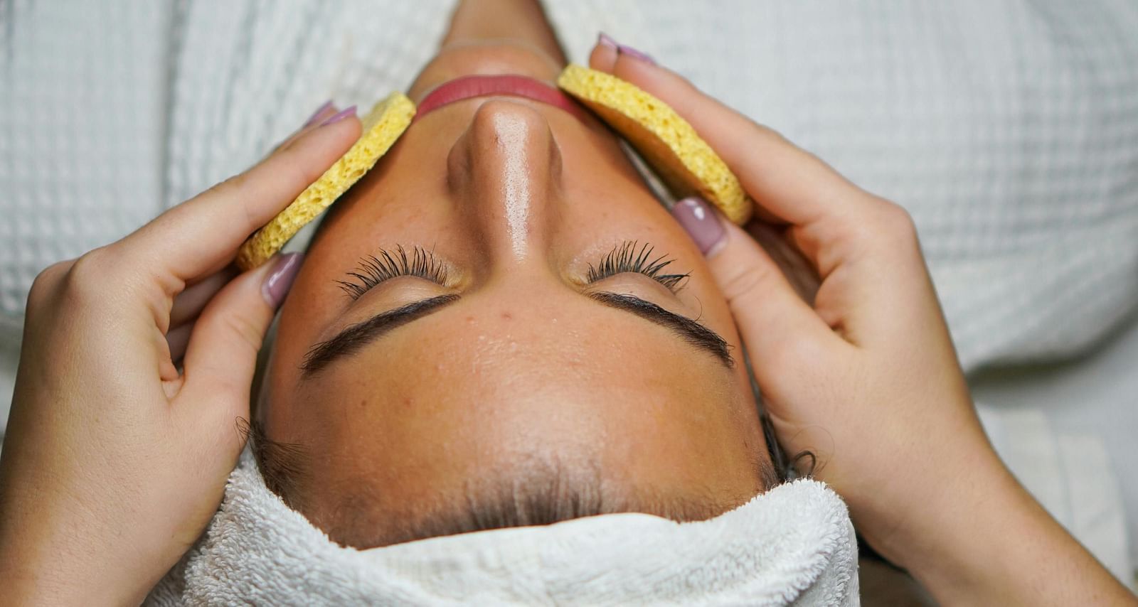 An image of a women getting done with facial