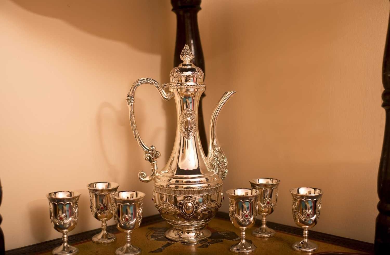 Elegant glassware and silver serving set displayed neatly at Jaypore360 Homestay.