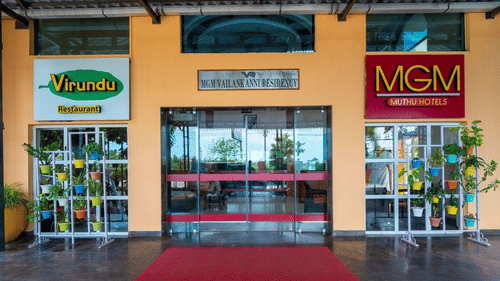 Main entrance of MGM hotel and Aayiram restaurant with red carpet and signage.