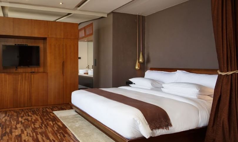 An image of a bedroom which also had a flat TV screen on the wall | Kavya Resort and Spa, Nagarkot