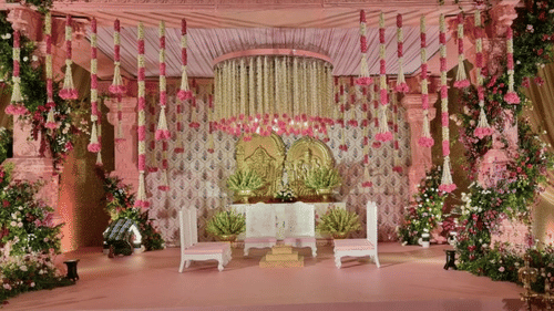 Elegant wedding stage adorned with pink floral arrangements at Central Heritage Resort and Spa.