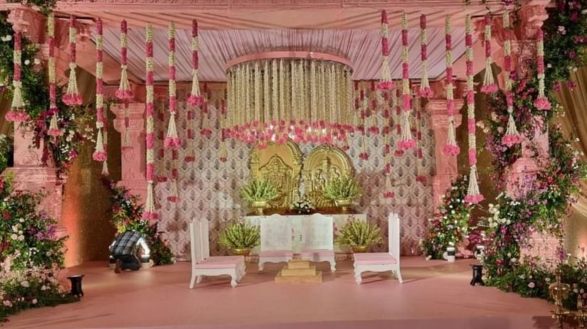 Elegant wedding stage adorned with pink floral arrangements at Central Heritage Resort and Spa.