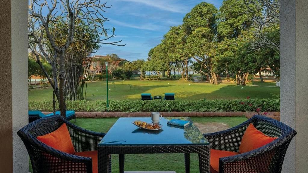 two chairs and a table in the balcony of a room - Caravela Beach Resort Goa