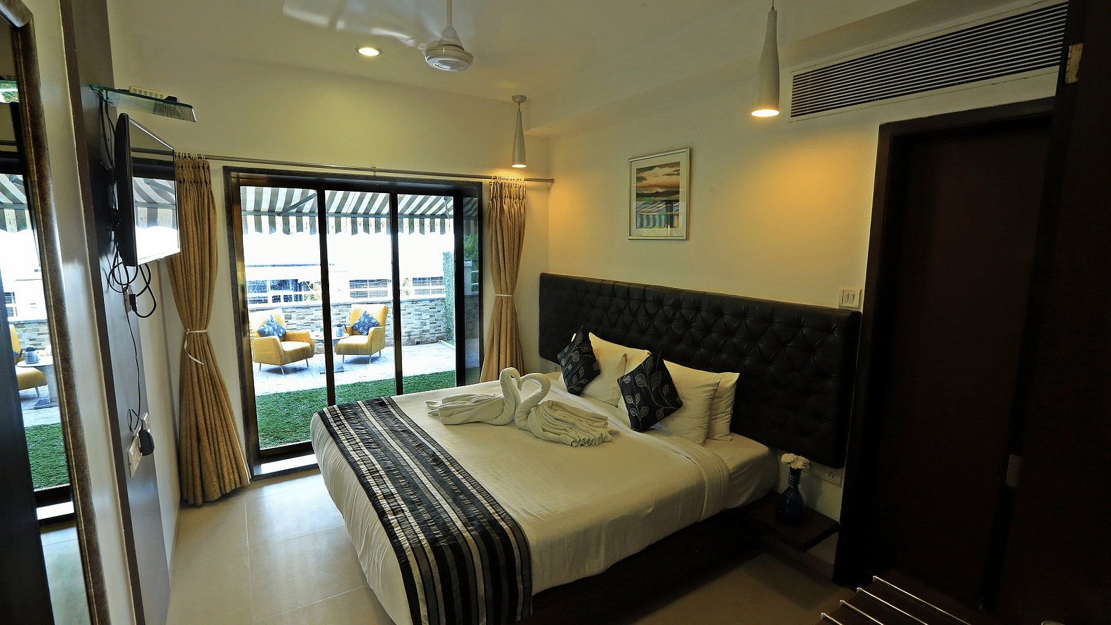Premium Garden Terrace Room with bed and large windows at The Oriental Residency