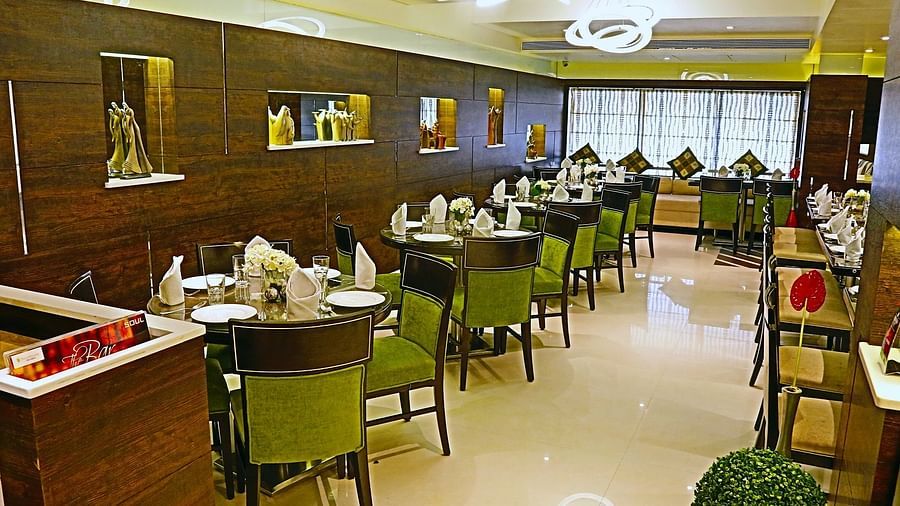 Image of dining space with tables and chairs at The Oriental Residency
