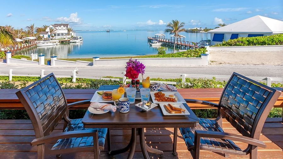 Outdoor breakfast setup with ocean view in the background | Abaco Inn