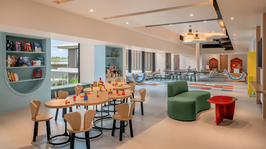 Kids' activity room with colourful seating and open shelving at The Residency Signature Madurai.