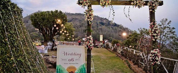 a decorated entrance for a wedding leading to the open space hall - neer ganga Resorts