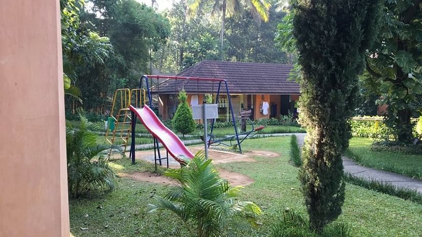 An overview of the Children's Play Area with a slide in view - Abad Green Forest, Thekkady.