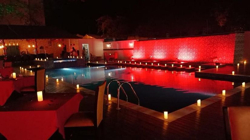 seating arrangements for dinner by the swimming pool - Wedlock Greens Hotel Resorts Dhanbad