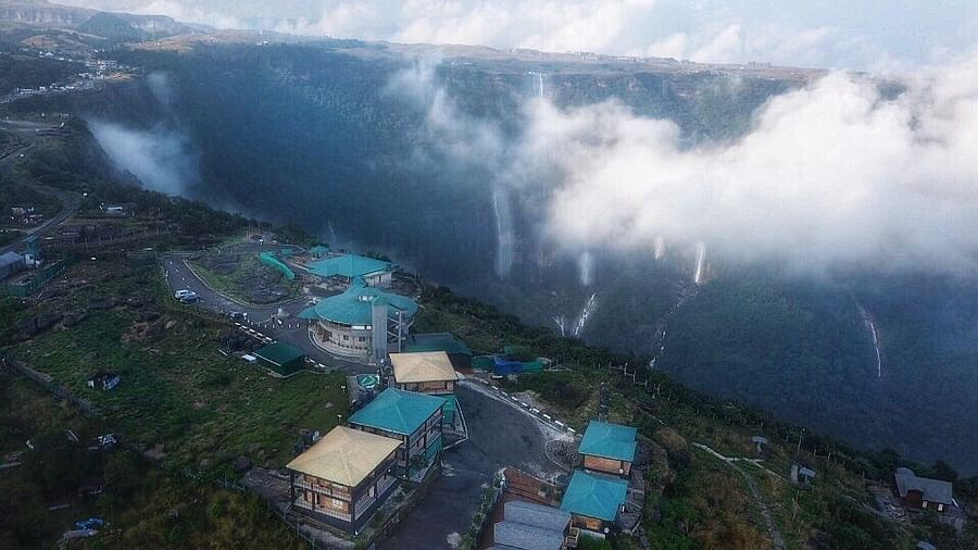 an aerial view of a hill station with clouds passing