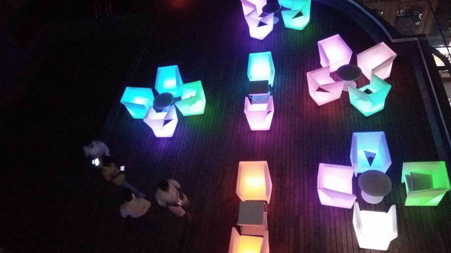 The Empresa Boutique Hotel - aerial view of the rooftop area with colourful seats beside the swimming pool