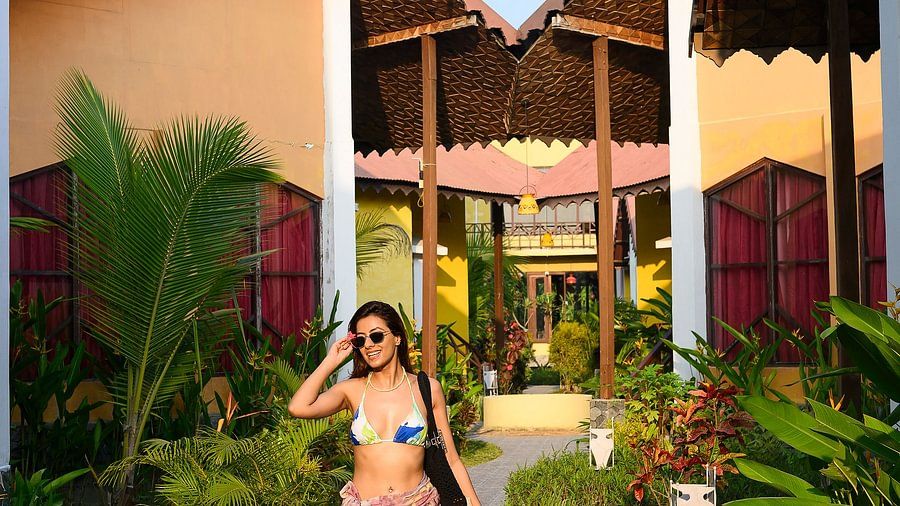 Woman strolling through resort walkway at Silver Sand Village Resort, Havelock