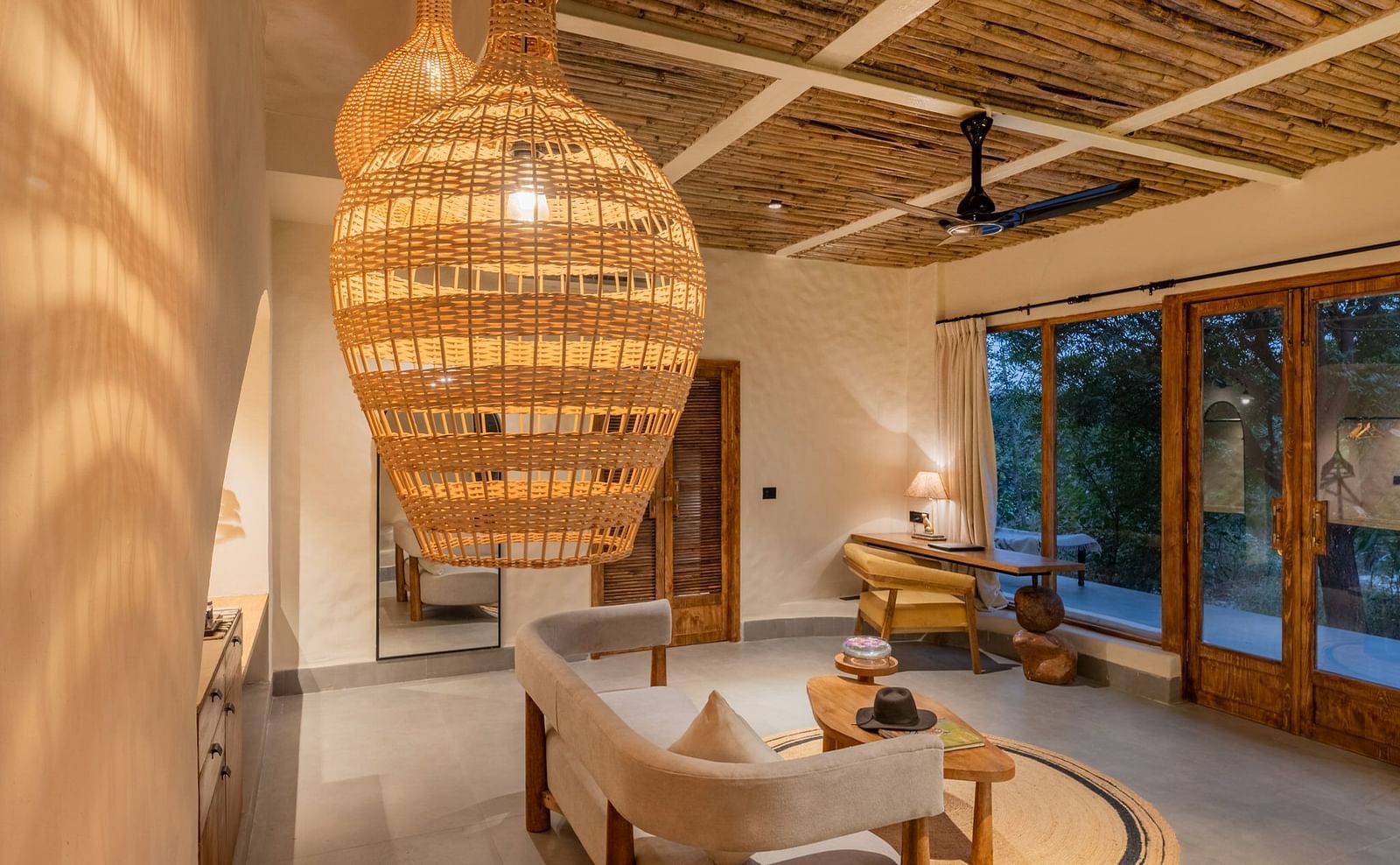 Interior view of a rustic-style dining area with hanging woven lights and wooden furniture.