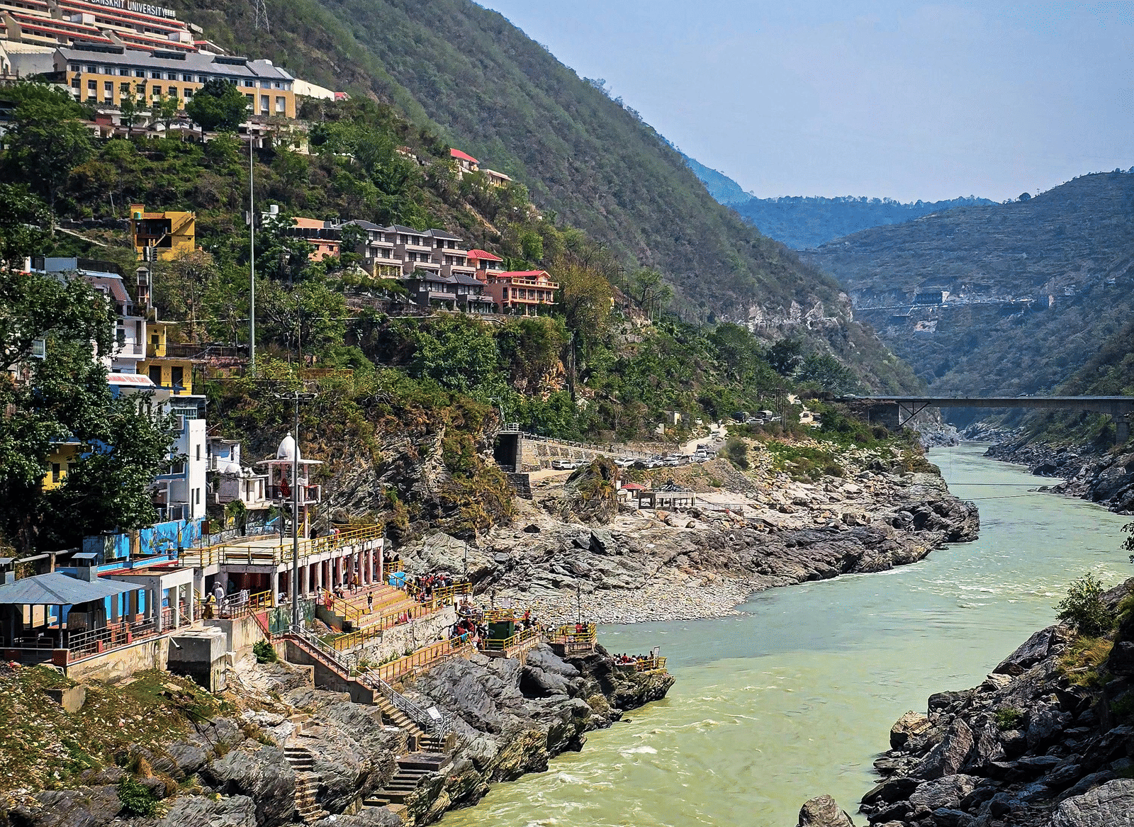 Two bodies of water meet with mountains in the background.