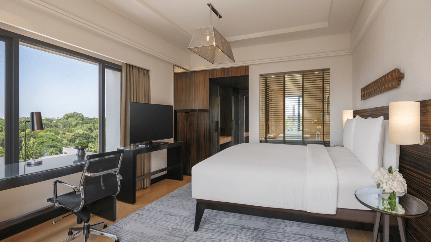 Bed with side lamps and wall decor at The Raintree, St. Mary’s Road.