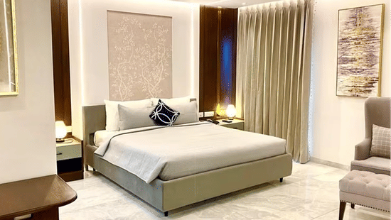 Hotel room interior with contemporary decor and neutral tones.