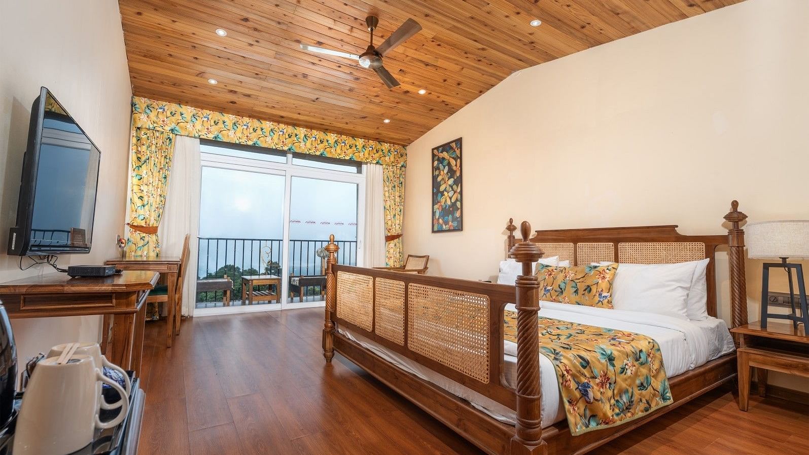 A room at Summit Barsana Resort & Spa, Kalimpong with a double bed, a television and a balcony